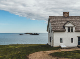Old historic white house next to Atlantic Ocean, Machias, Maine