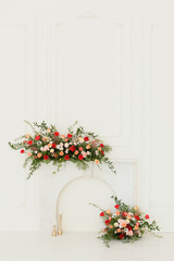Elegant florals on a white mantle with roses and greenery