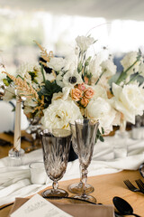 Elegant table setting with floral centerpiece, glasses, and candles