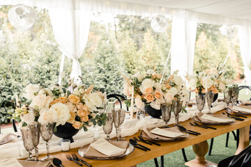 Table setup with floral centerpieces and crystal glasses