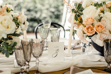 Elegant table setting with florals, crystal glasses, and table number