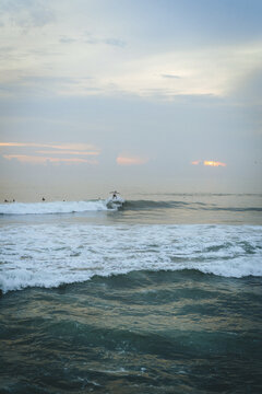 Man surfing at sunset, Bali, Canggu.