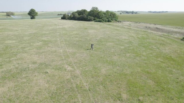 A Man Using a Metal Detector Start Digging