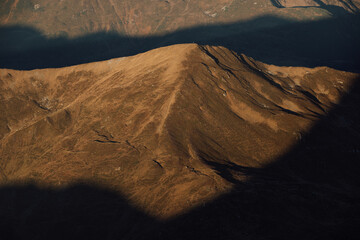 Autumn morning in mountains gold-lit shadow and light