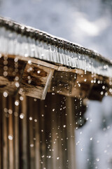 Melting snow dripping from a roof in Kitzbühel ski area