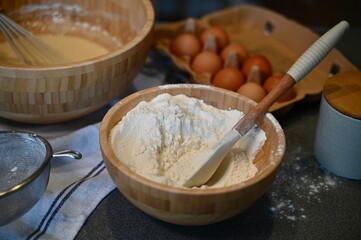 Flour in a wooden bowl to prepare pancake dough