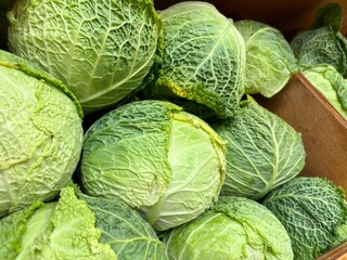 Fototapeta premium Close-up of green cabbages in a wooden box at NYC market