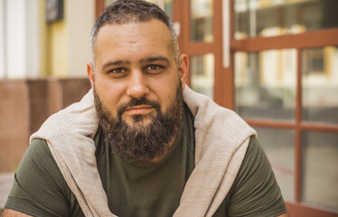 Portrait of bearded men at city street, close up. Guy with good mood. Philosophy of modern men