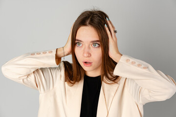 Young Woman Showing Surprise Expression on Gray Background