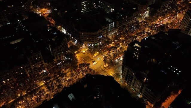 Top view of Eixample street in Barcelona, Spain at Night. Yellow lights and cars driving. Square district.