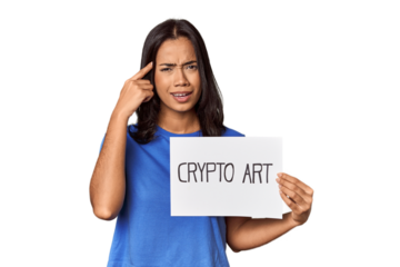 Woman with "crypto art" sign in studio showing a disappointment gesture with forefinger.