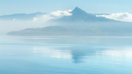   A vast expanse of water stretches before you, with a majestic mountain looming in the background and wispy clouds scattered across the sky above