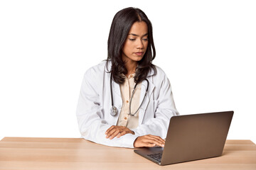 Thoughtful Filipino vet at desk, focused on care
