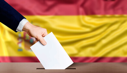 Hand holding ballot in the ballot box with the flag of Spain in the background. Spain general elections, voting concept