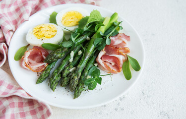 Fresh Asparagus and Prosciutto Salad Served With Boiled Eggs and Microgreens