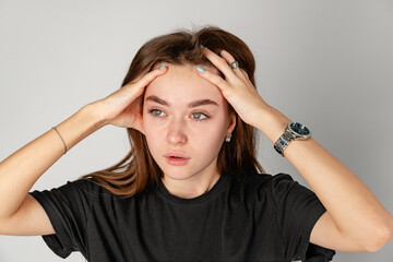 Young Woman Holding Head in Hands because of headache