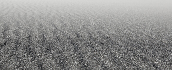 Black sand waves as background on sunlight