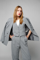 Woman in Gray Suit and White Shirt posing in studio