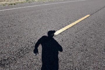 shadow of person on road
