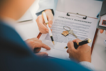 Real estate agent talked about the terms of the home purchase agreement and asked the customer to sign the documents to make the contract legally, Home sales and home insurance concept.