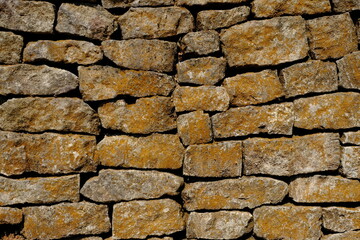 natural stone wall. box-shaped natural stone stacked into a natural stone wall. limestone, andesite, marble is often used for natural stone walls. this stones is a good architectural element.