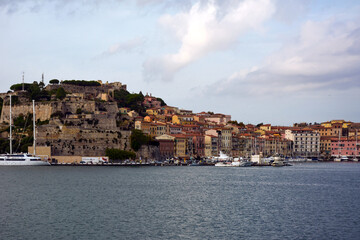 Picturesque bay of the port of the old sea town with low-rise buildings and yachts at the pier