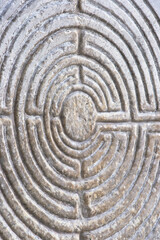 Labyrinth carved on the stone facade of a Romanesque church of the 11th century (Tuscany - Italy)