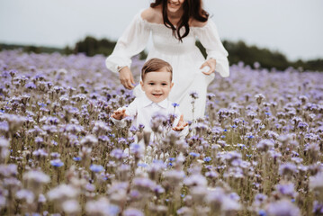 mother and son on the background of a blooming purple field