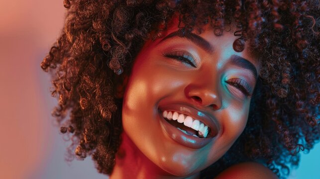 Girl Smiles Playfully, Acts and Plays with Facial Expressions in Professional Studio. Fashion Magazine Photoshoot. Portrait Shot of Attractive Black Girl with Lush Curly Hair.