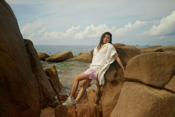 woman sitting on the rocks