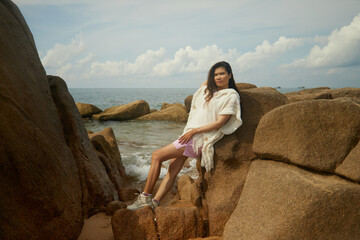 woman sitting on the rocks