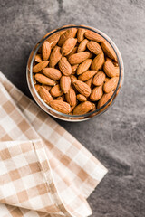 Peeled almond nuts in bowl, Top view.