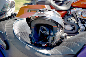 A detailed close up of a sleek, black helmet resting on a motorcycle, ready for the next thrilling...