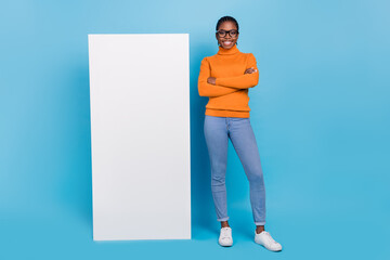 Photo of self-assured manager lady blank wall card empty space wear specs orange sweater isolated...