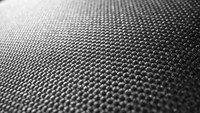 Behold the elegance of black polyester fabric, boasting a refined woven pattern. Its subtle gleam and meticulous weave exude modern sophistication, ideal for diverse uses.
