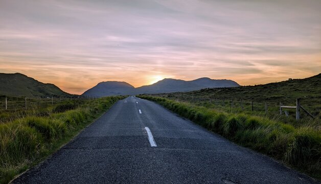 Empty scenic road trough nature and mountains at sunset, Inagh valley, Connemara, Galway, Ireland, landscape background, wallpaper
