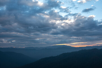 Mountain Sunset with Clouds, a Breathtaking Landscape Bathed in Evening Light and Mist, Capturing...