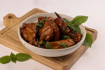 Three Cup Chicken or San Bae Ji is Braised Chicken in a Sweet and Savory Broth  with Thai Basil. 