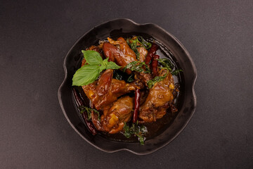 Three Cup Chicken or San Bae Ji is Braised Chicken in a Sweet and Savory Broth  with Thai Basil. 