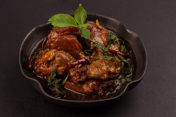 Three Cup Chicken or San Bae Ji is Braised Chicken in a Sweet and Savory Broth  with Thai Basil. 