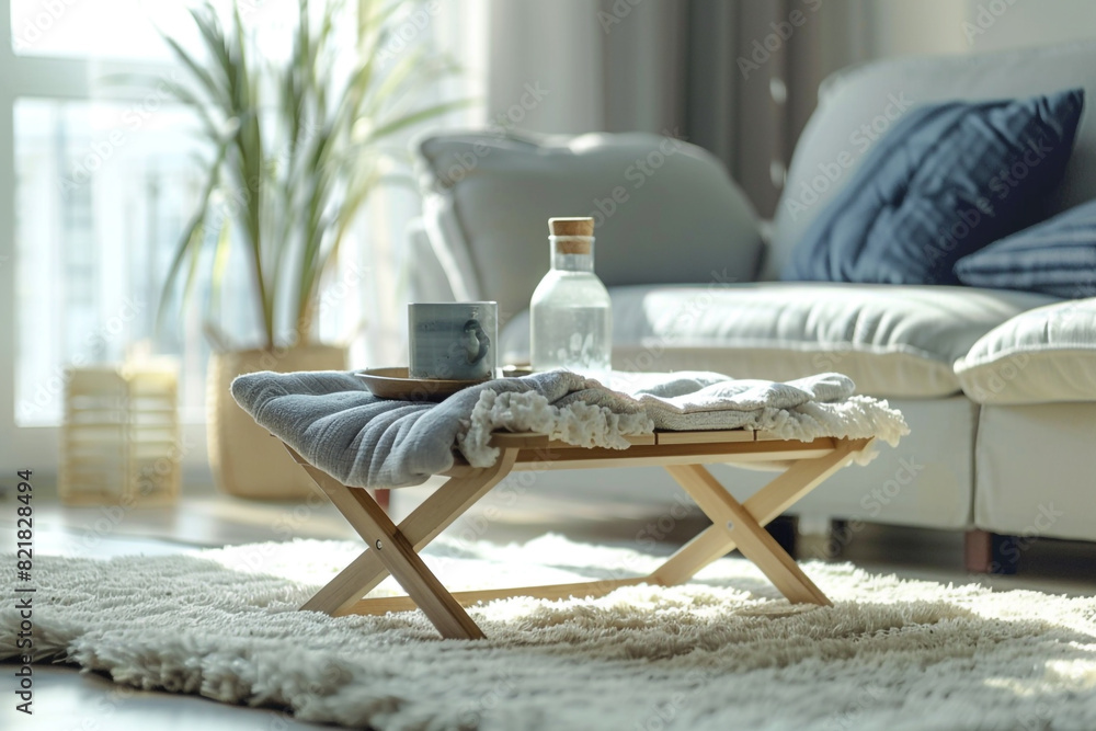 Poster sofa with coffee table by window in living room folding portable stool is kept on carpet at home int