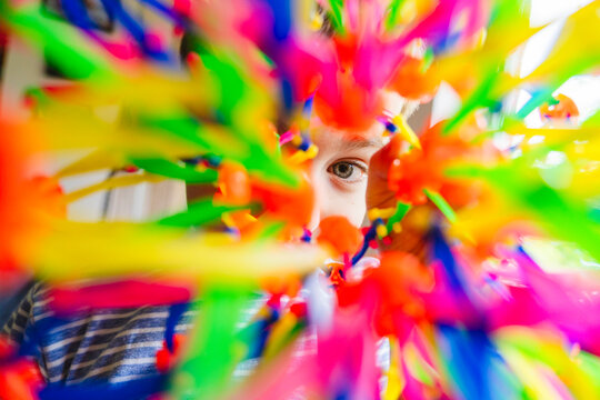 Curious boy looking through colorful expandable breathing ball