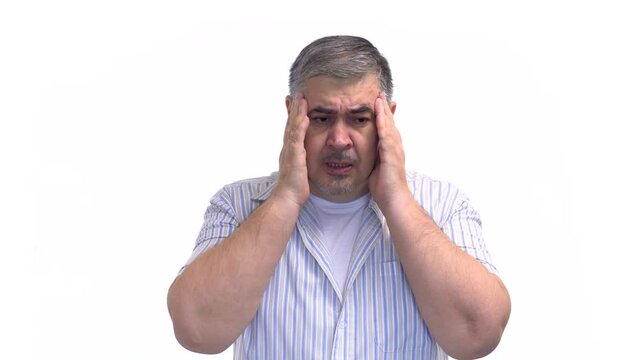 A man massages his temples to relieve headache pain caused by conditions like migraines, overwork, or vascular spasms. White background.