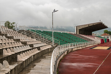 Stadium bleachers in stadium on cloudy day