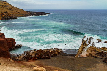 A litte black sandy beach Playa de los Clicos   in El Golfo bay.  Atlantic ocean, Lanzarote, Canary...