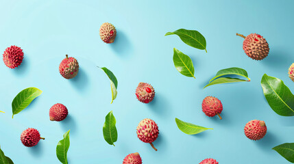 Fresh lychees with green leaves falling on light blue background