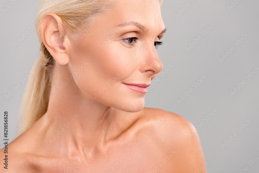 Poster Photo of sweet adorable senior lady nude shoulders looking empty space isolated grey color background