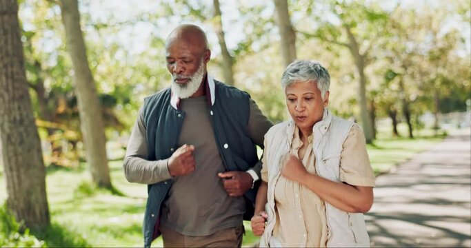 Interracial, senior couple and walking with partner in park for fitness, workout or cardio exercise. Man and woman in nature, road or street of woods for outdoor training, health and wellness