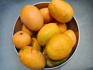 Mango in basket, yellow ripe mangoes 