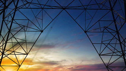 Close up bottom view electricity overhead power lines on sunset sky in Jakarta Indonesia.